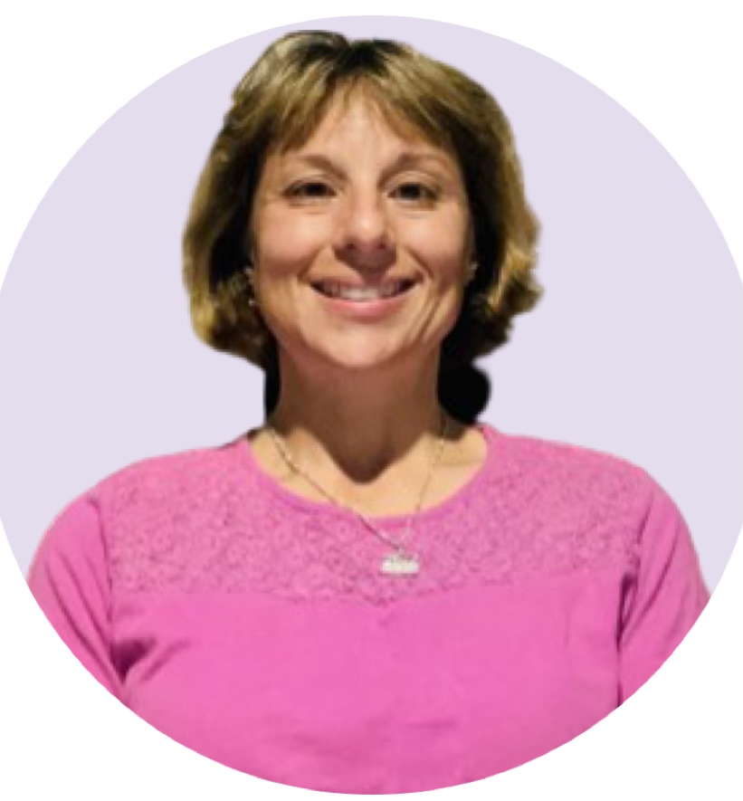 Woman, smiling, with brown hair and wearing a pink shirt